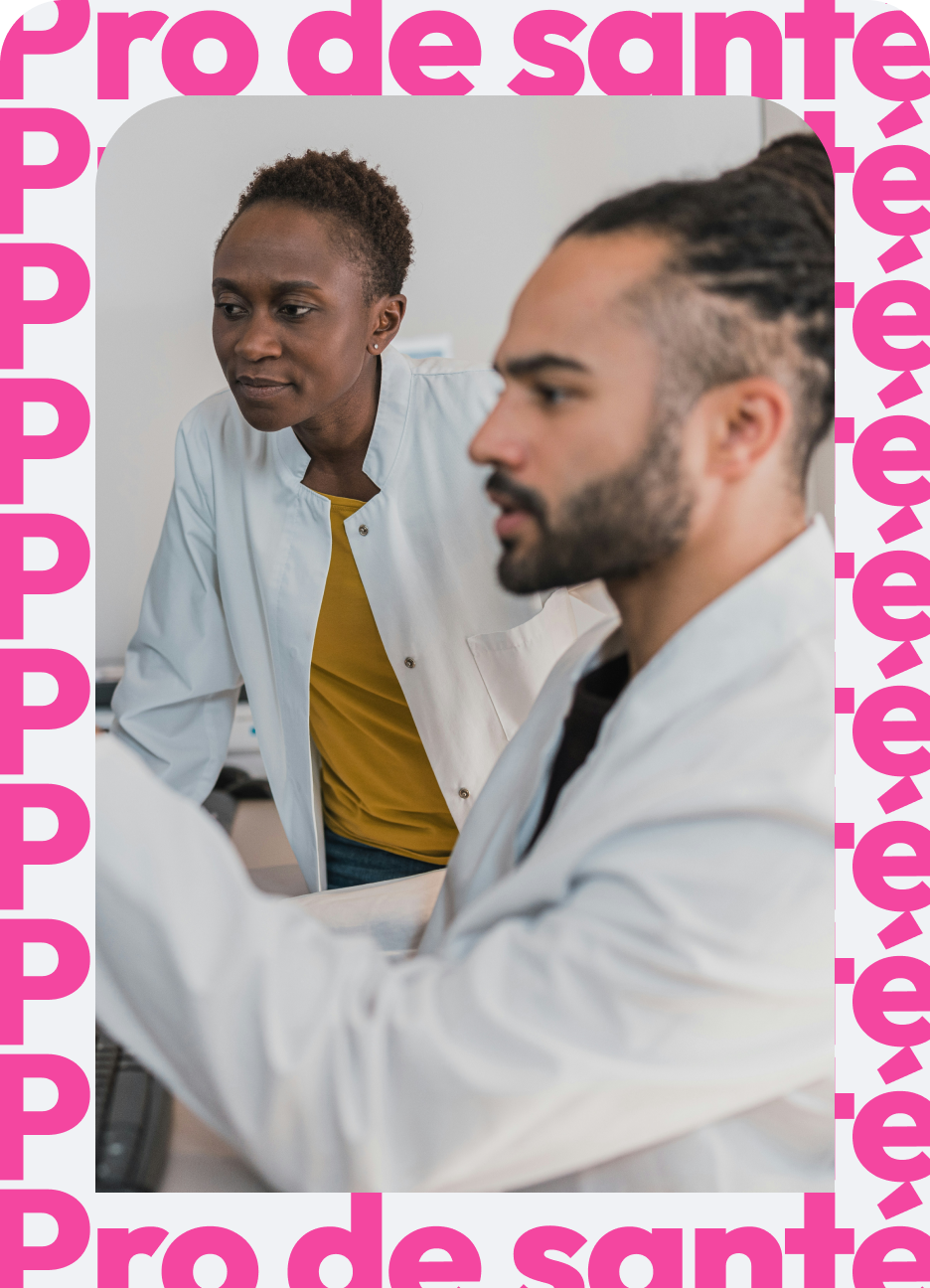 Two medical professionals in white lab coats, one focused on a computer screen and the other observing attentively, in a clinical setting.