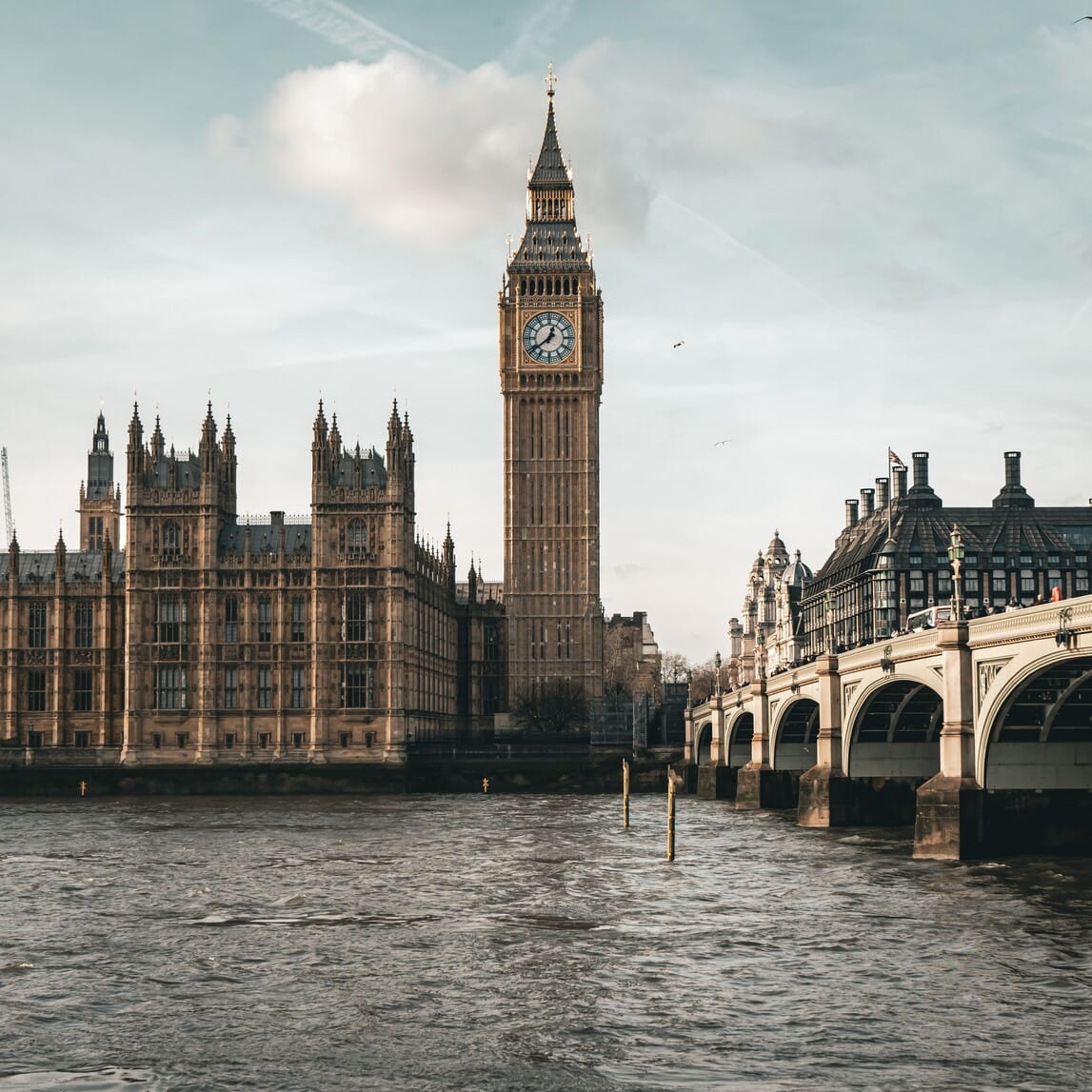 View of Big Ben and the Houses of Parliament with the Thames River and Westminster Bridge in London.