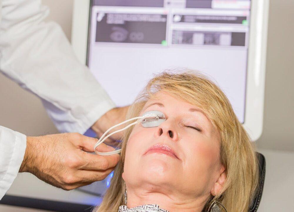 Patient undergoing LipiFlow vectored thermal pulsation treatment with the activator in place