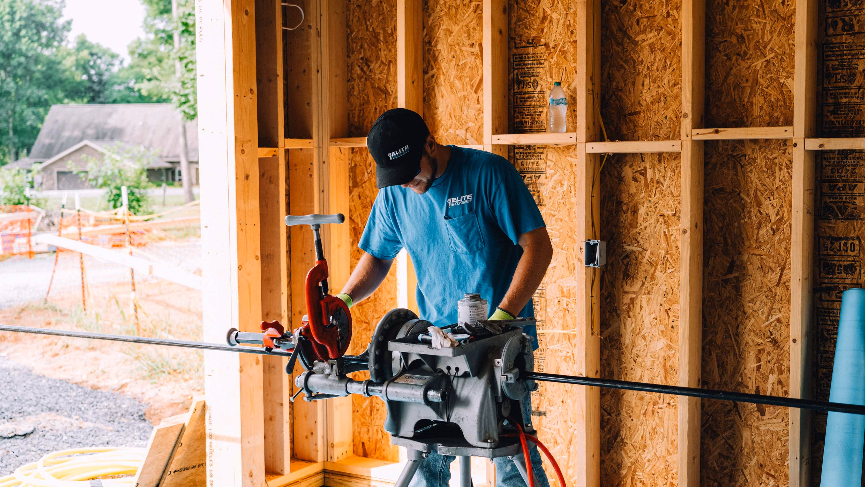 Plumber working on gas lines during new construction plumbing.