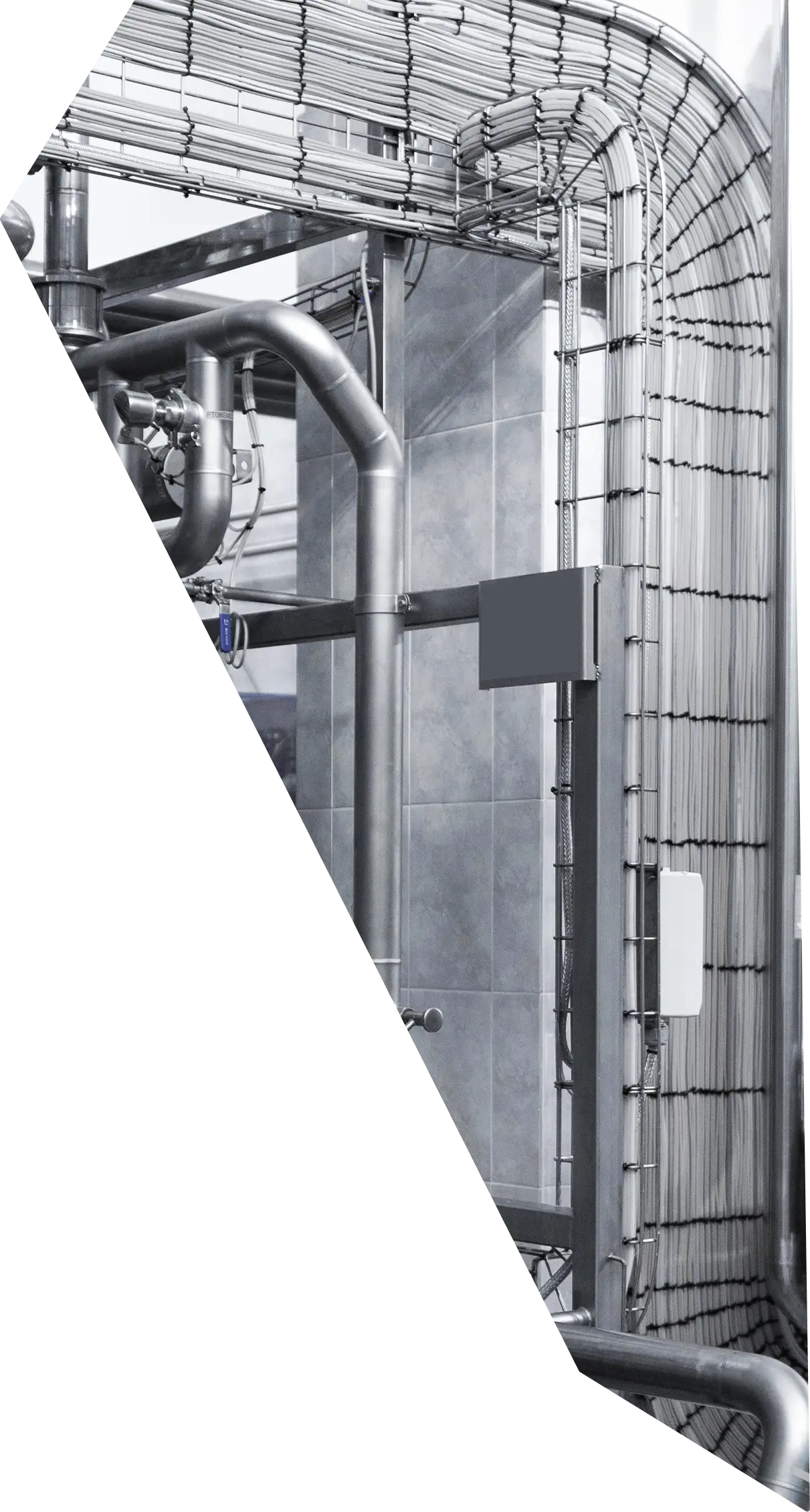 A geometric logo inspired shape filled with an image an industrial building