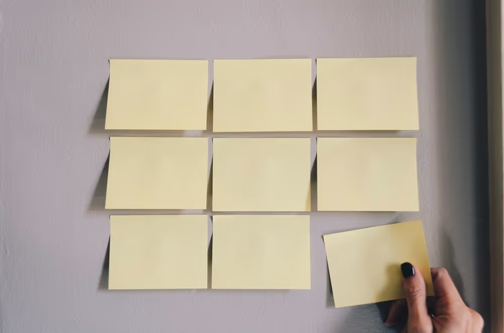 An image of a wall with sticky notes on it as a person plans their martial arts marketing strategy.