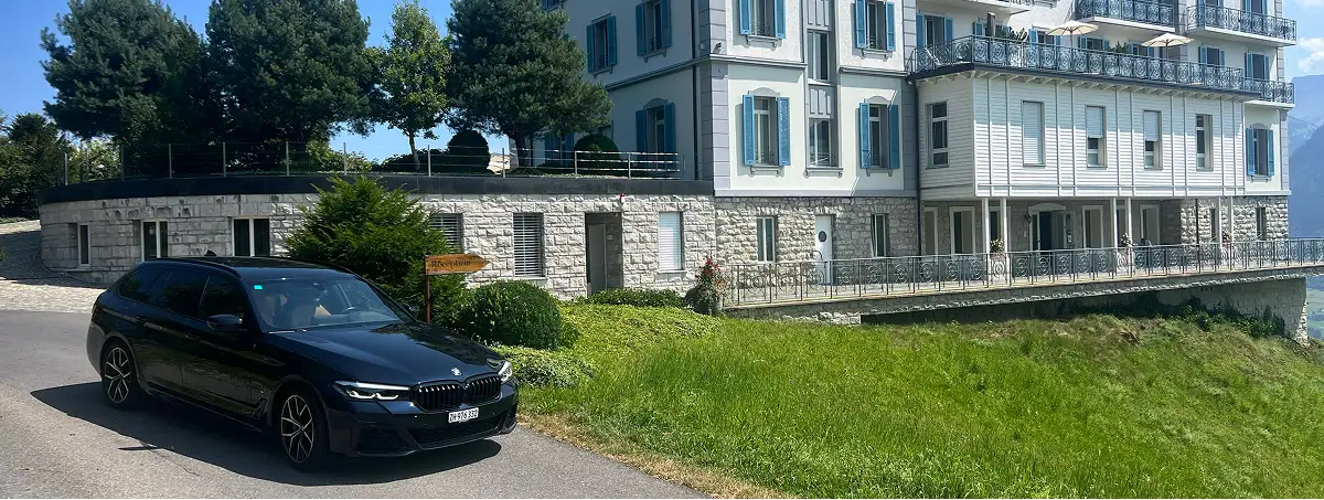BMW Serie 5 per servizio chauffeur business a Zurigo davanti a un hotel di lusso in Svizzera