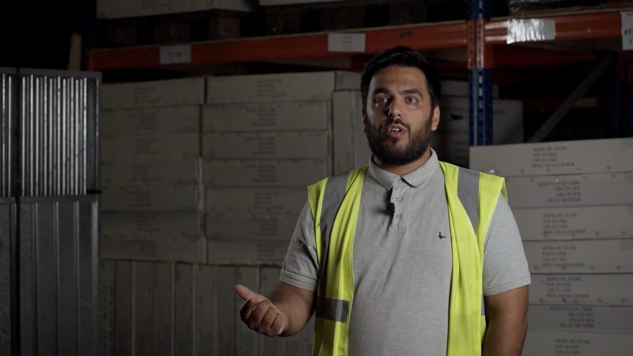 James Marsdon from Dog Health talking to camera in a warehouse