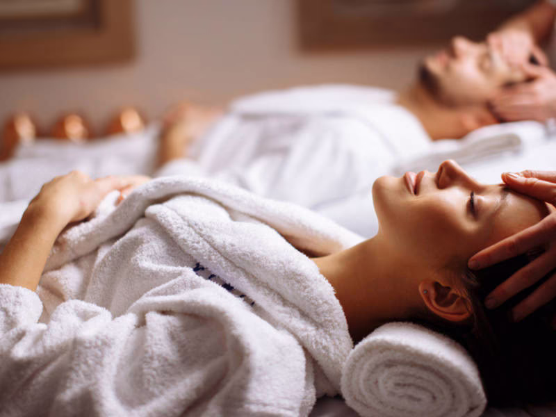 Couple relaxing side by side during a couples massage at DASA Spa on the San Antonio Riverwalk