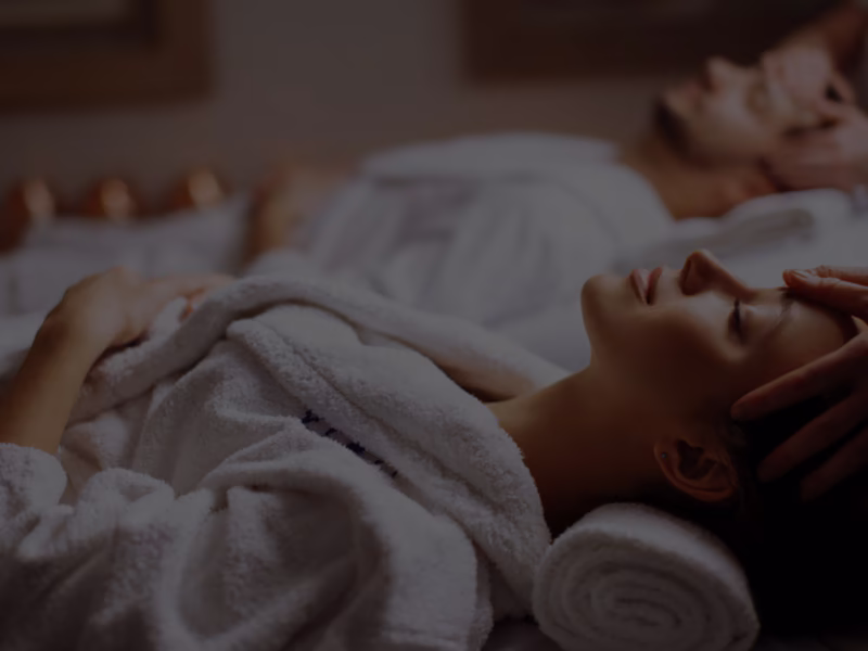 Couple relaxing side by side in robes during the Relaxation for Two journey at DASA Spa