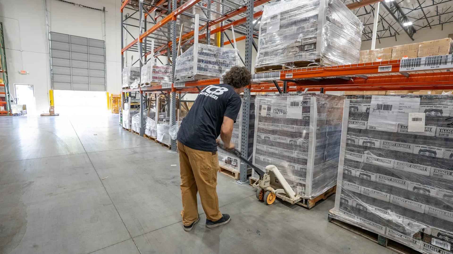 TCB warehouse team member moving palletized beverage inventory