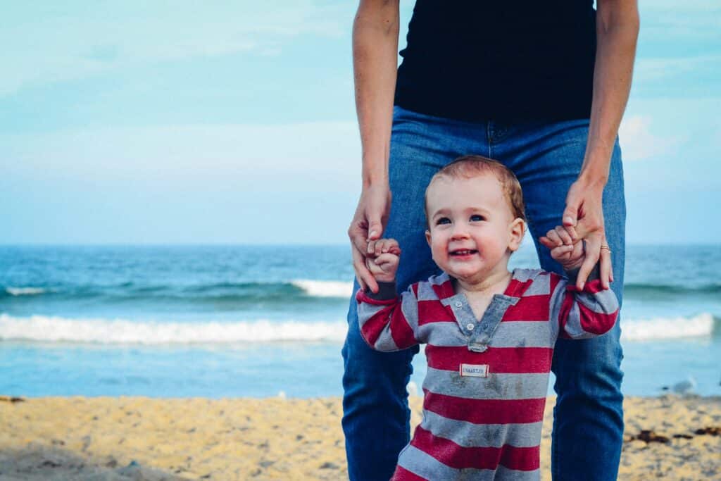 baby walking with parent