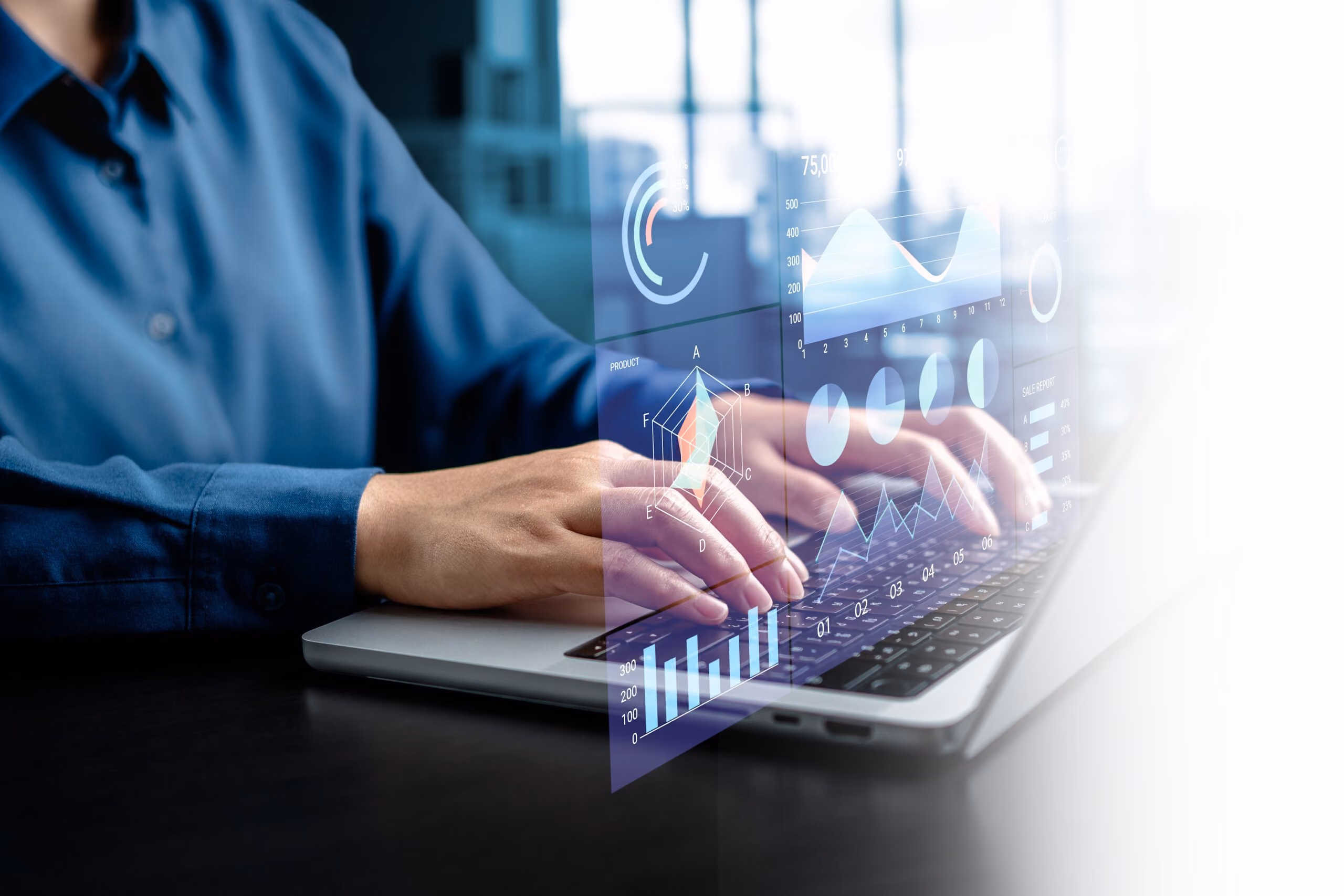 Person in a blue shirt typing on a laptop with digital data charts and graphs overlaid on the image, including bar charts, pie charts, and line graphs indicating data analysis or business analytics.