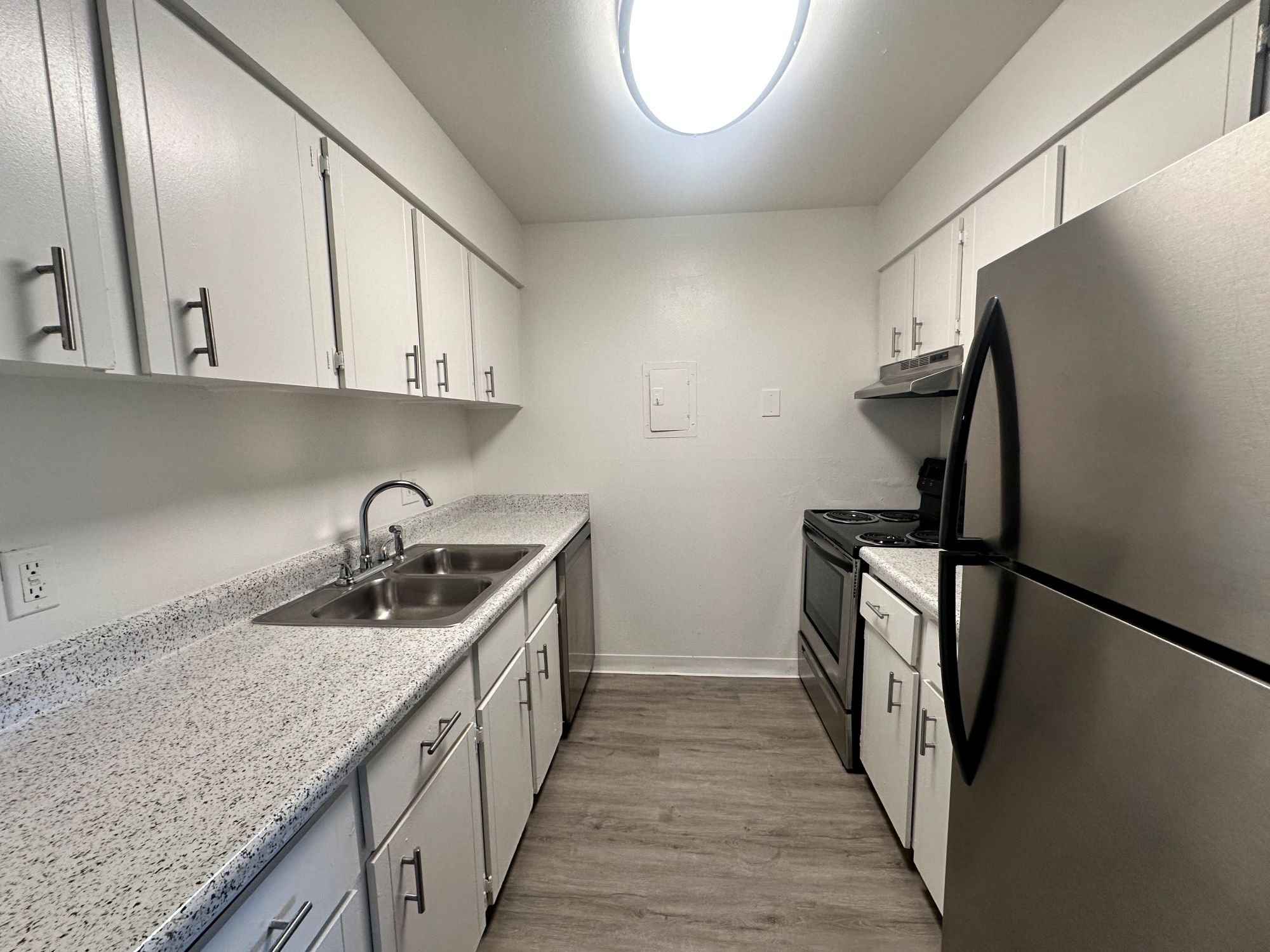 Kitchen with stainless steel appliances and view of washer and dryer and dining area, corner view