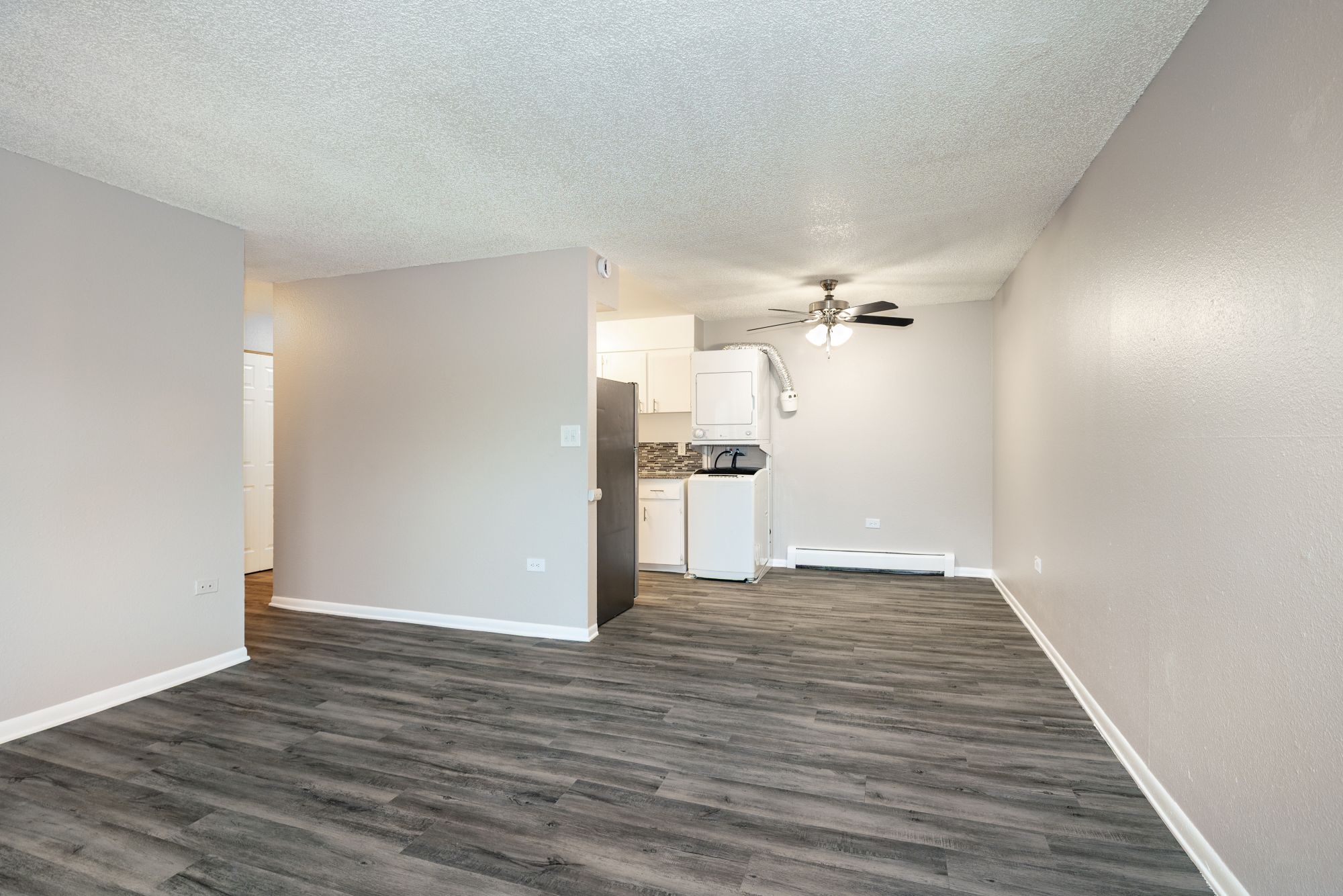 Dining area with ceiling fan and view of living room and kitchen