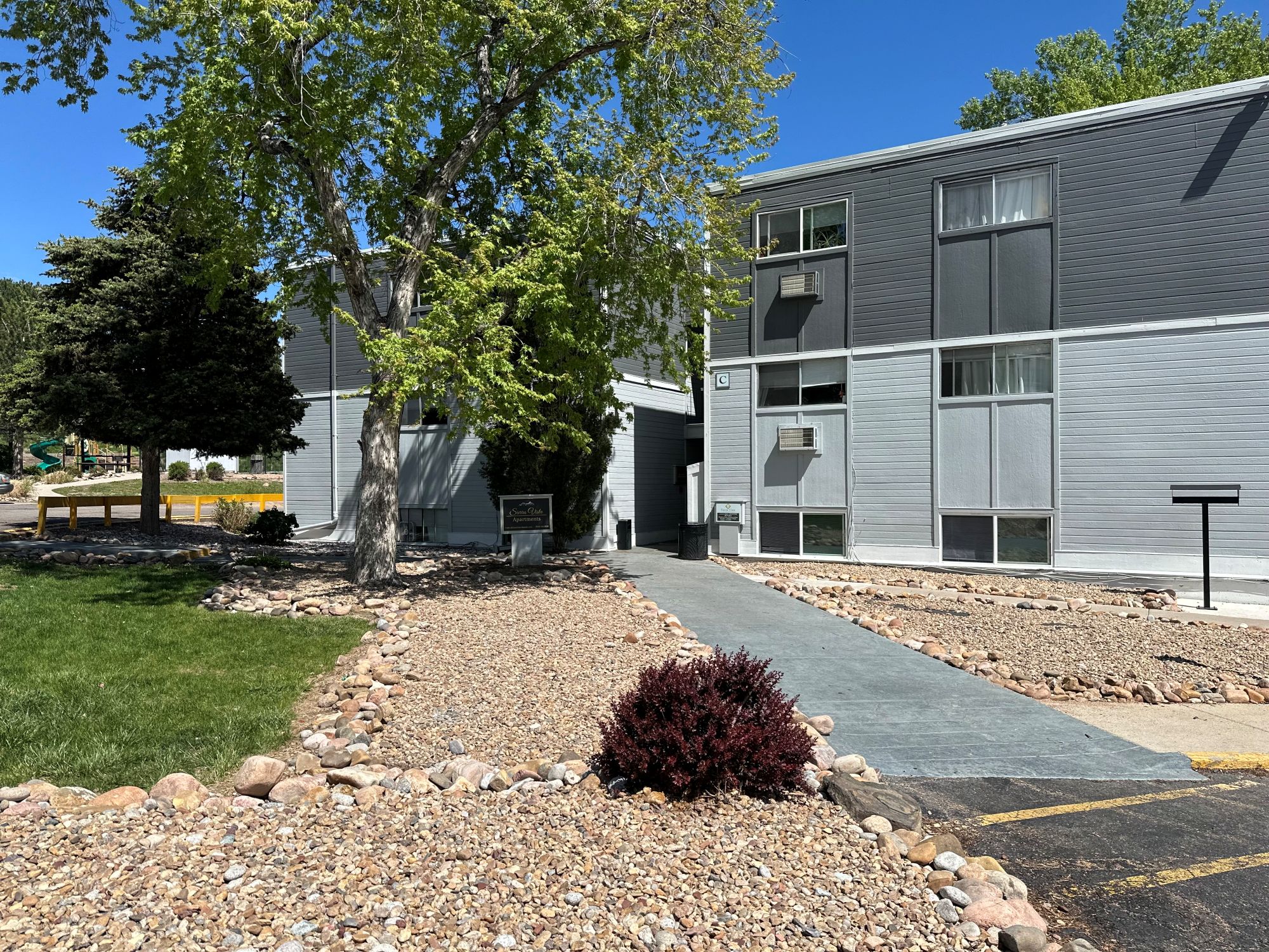 Exterior of community with open green space and trees