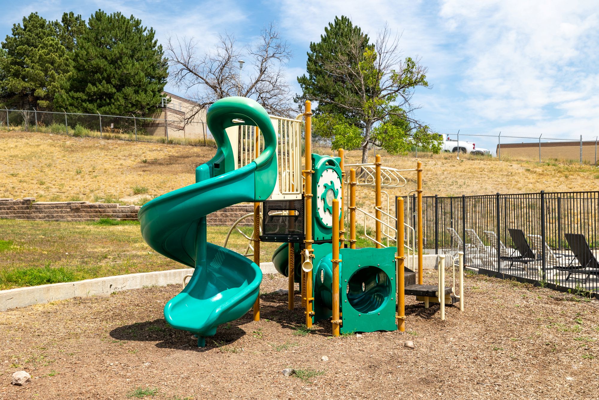 Community playground with view of parking area