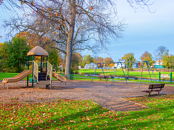Children's playground in Brookside Park featuring slides and swings