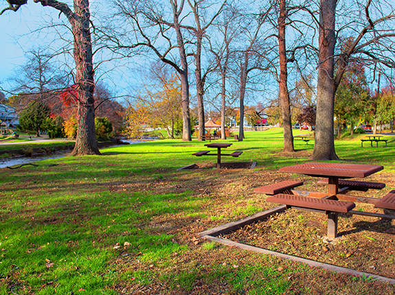 Picnic table area in Brookside Park with view of stream and gazebo