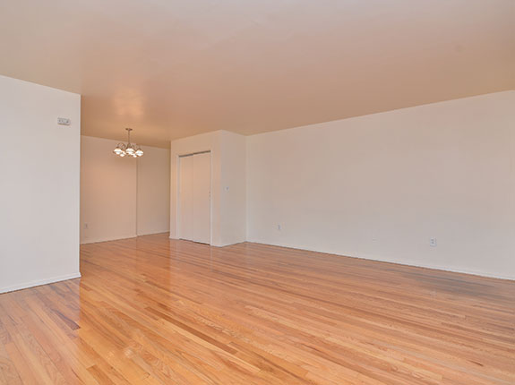 Empty living room featuring shiny hardwood floors