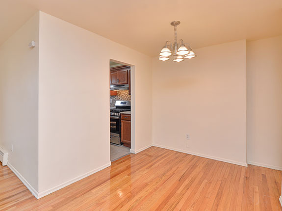 Empty dining room featuring shiny hardwood floors