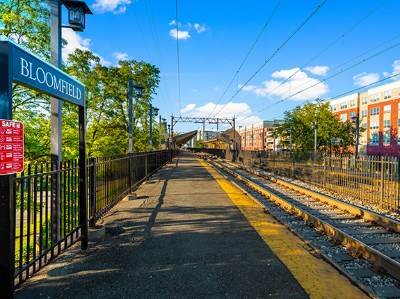 Bloomfield train stand with view of tracks and buildings