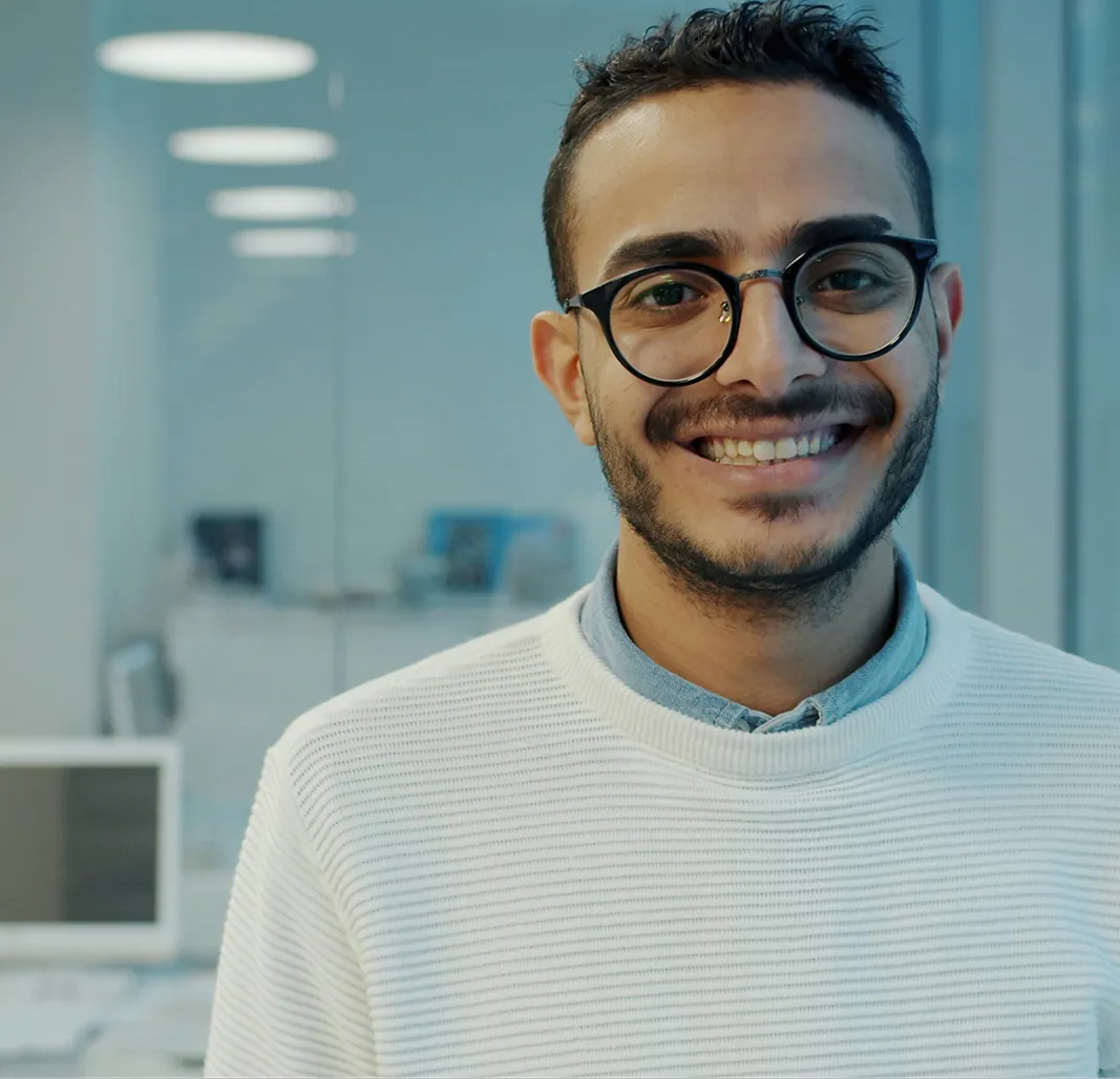 Physician smiling while reviewing patient notes