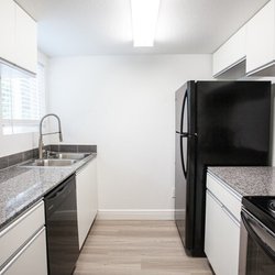 Kitchen with black appliances and white cabinets