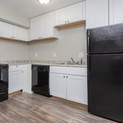 Kitchen with black appliances and white cabinets