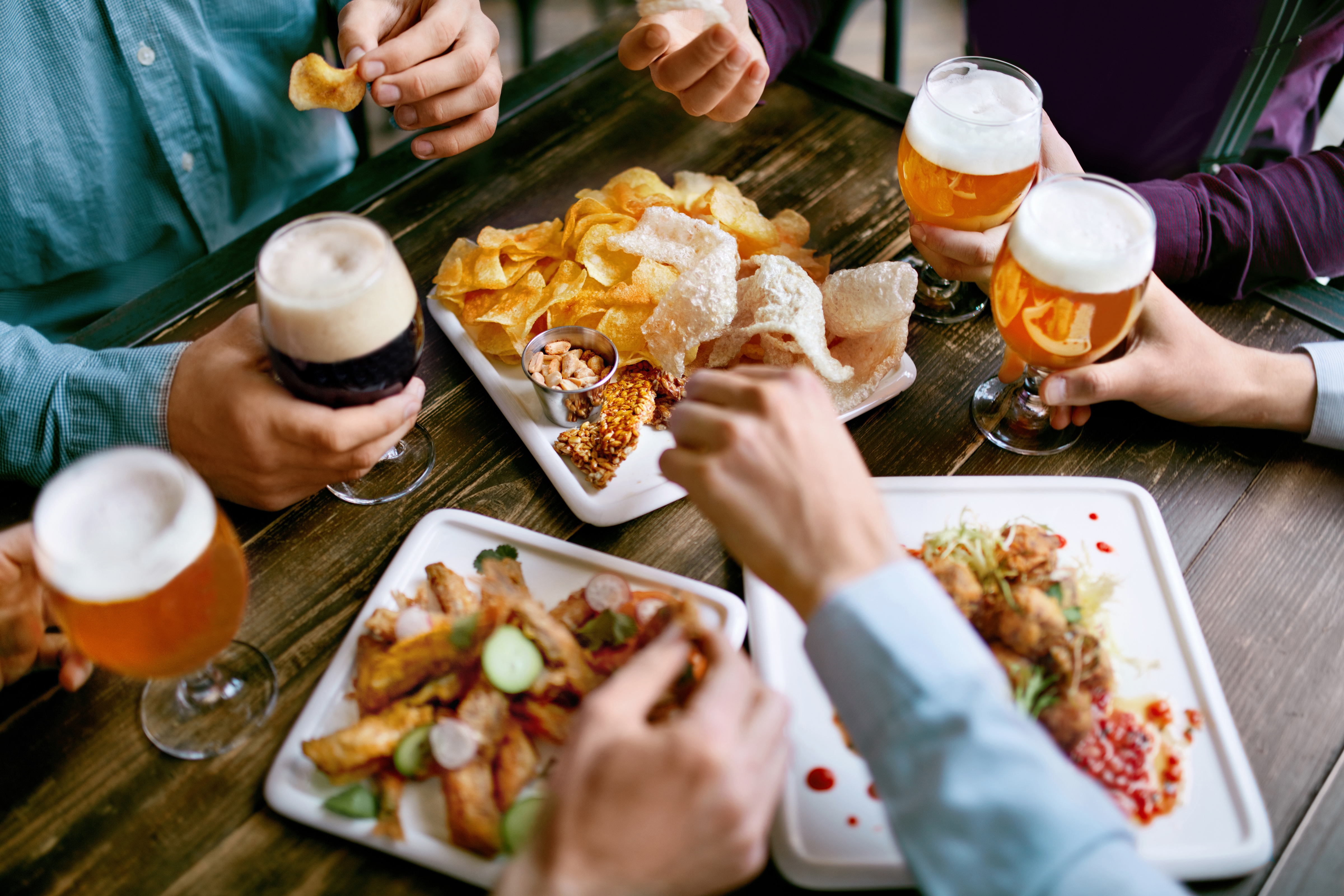 People drinking beer and bar food stock image