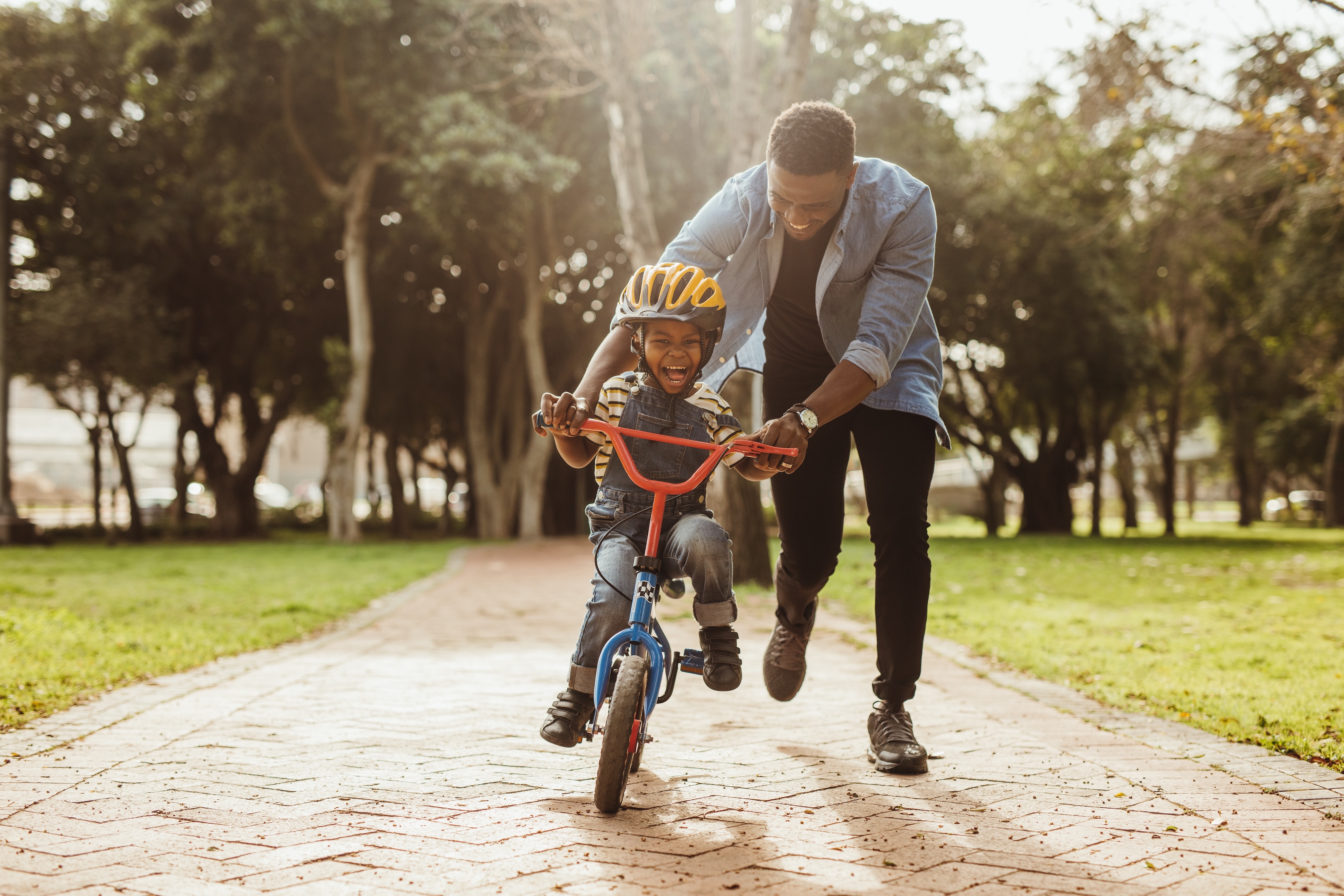 Man helping child on bike stock image