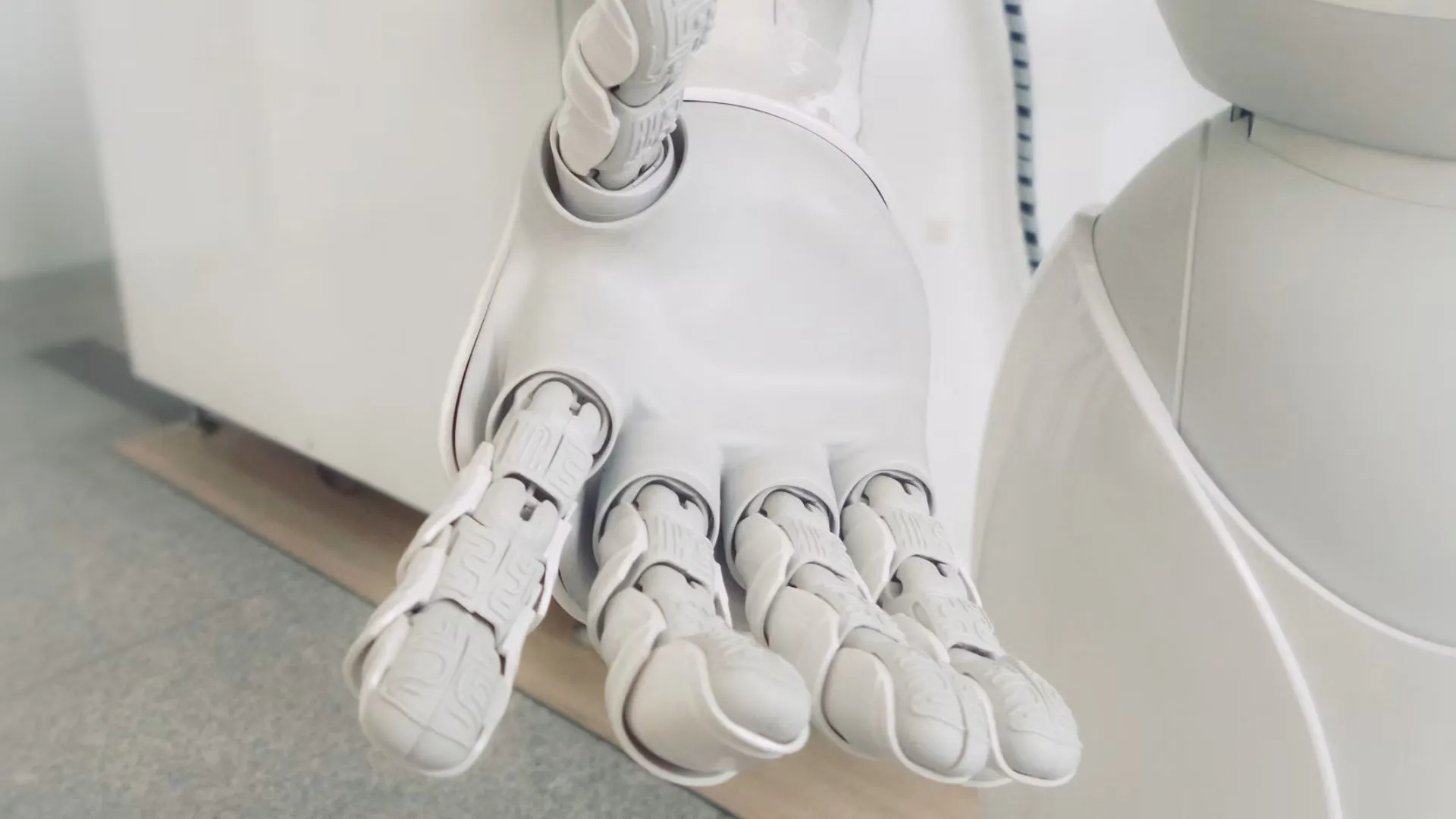 A white humanoid robot hand resting open