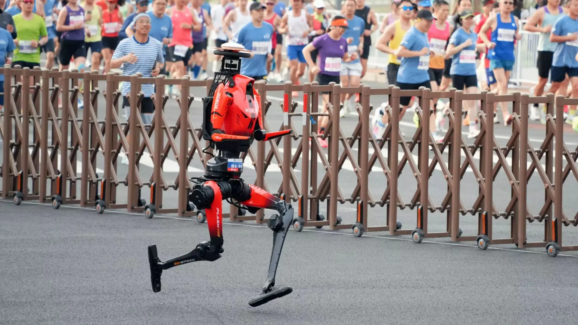 A runner on carbon blades racing past a crowd