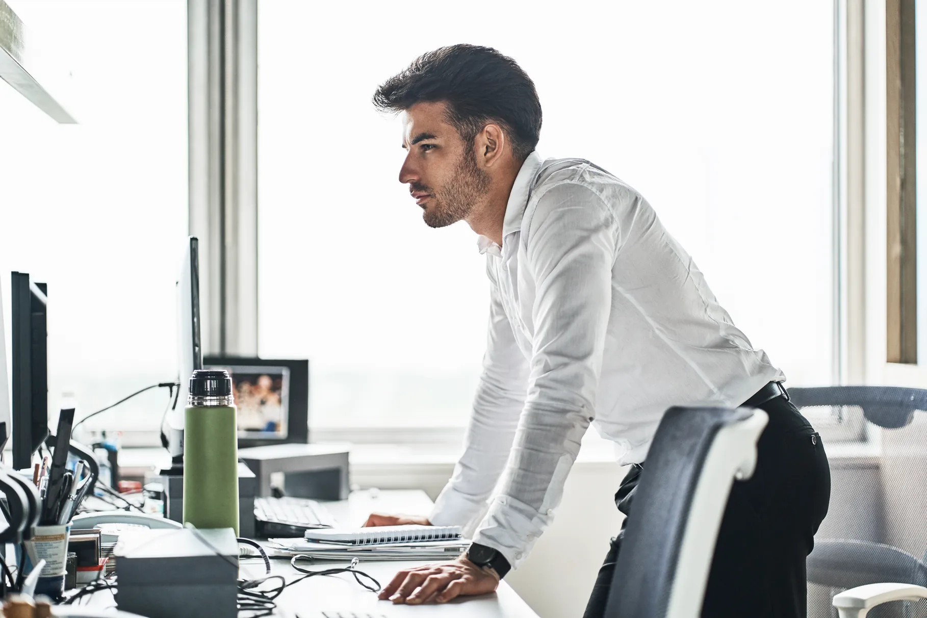 A senior executive working through a document at a desk