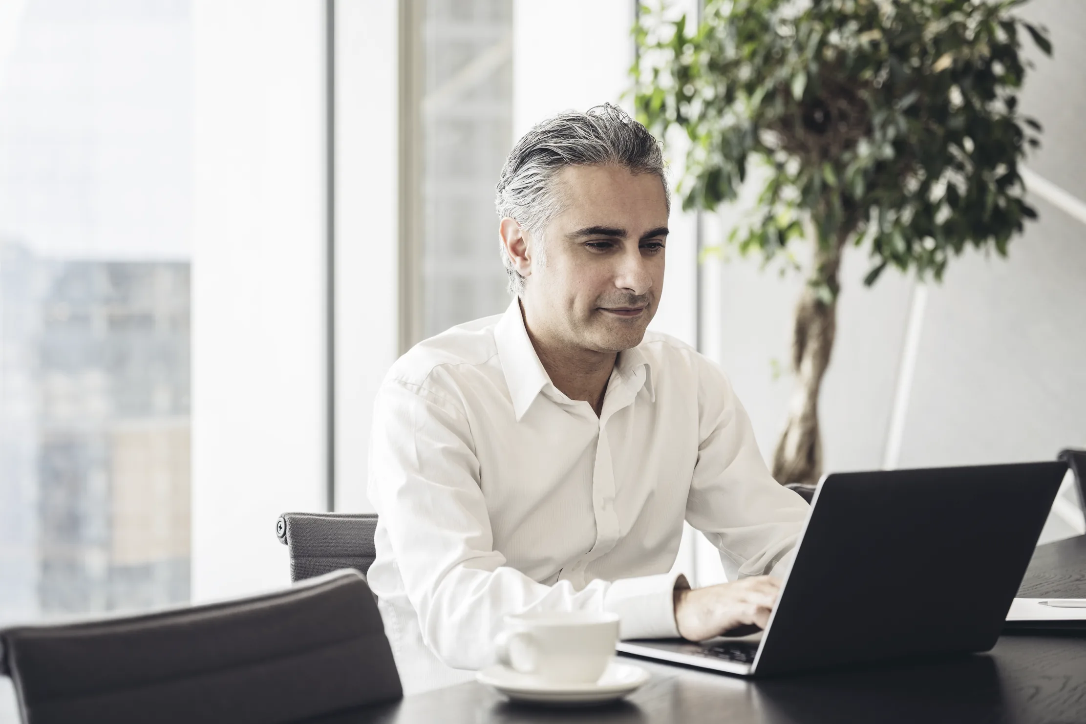 A chief executive at the head of a boardroom table