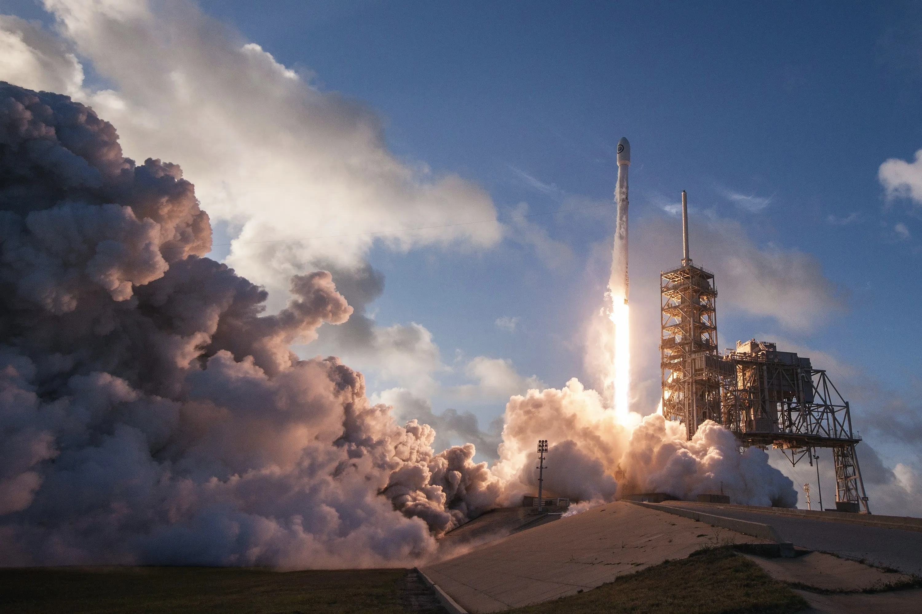 A rocket lifting off its pad into heavy cloud