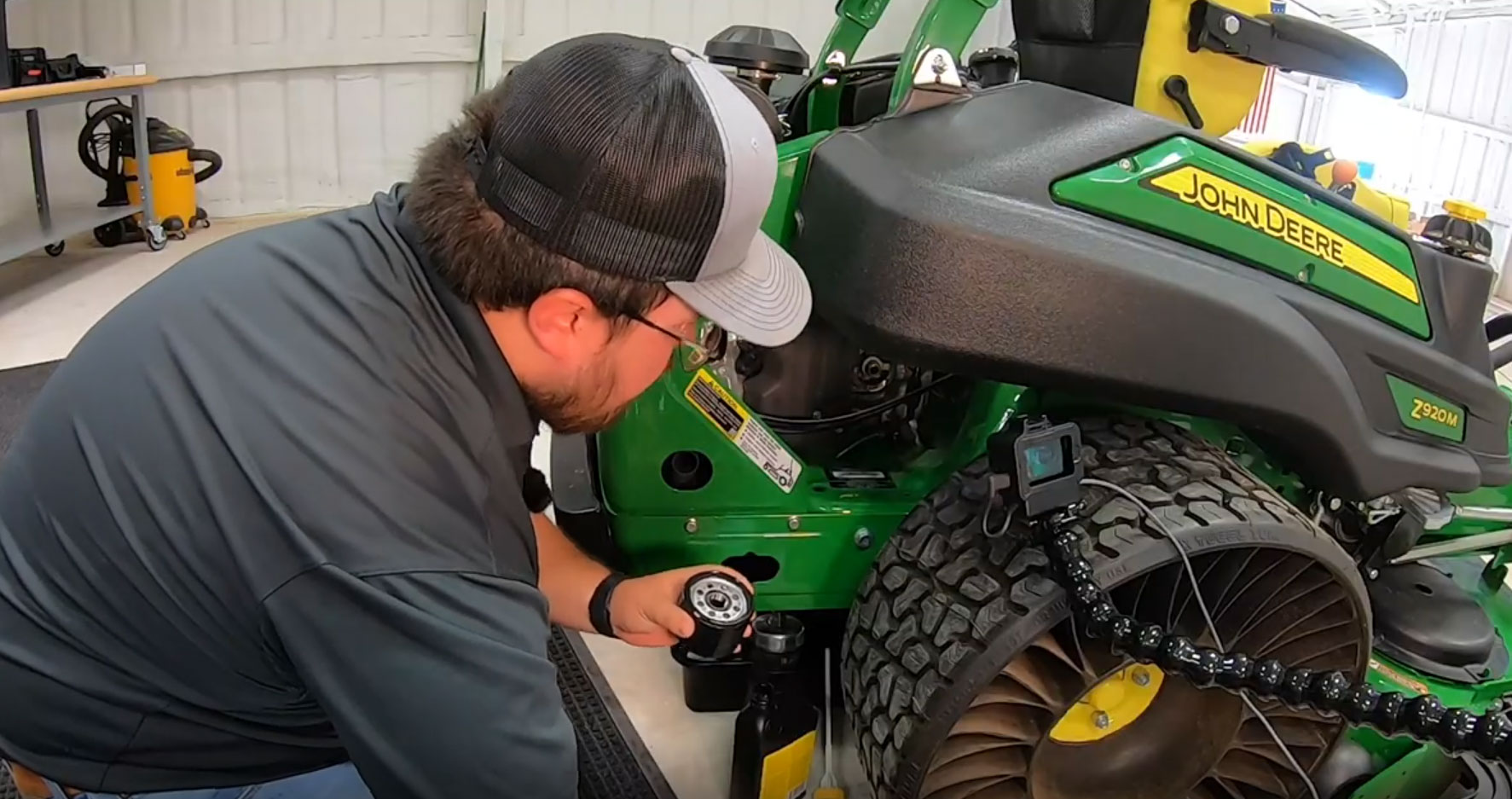 Man Servicing a John Deere Mower
