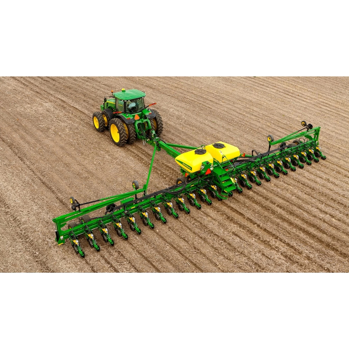 Overhead view of DB60 24Row30 Planter pulled through a field by a large tractor