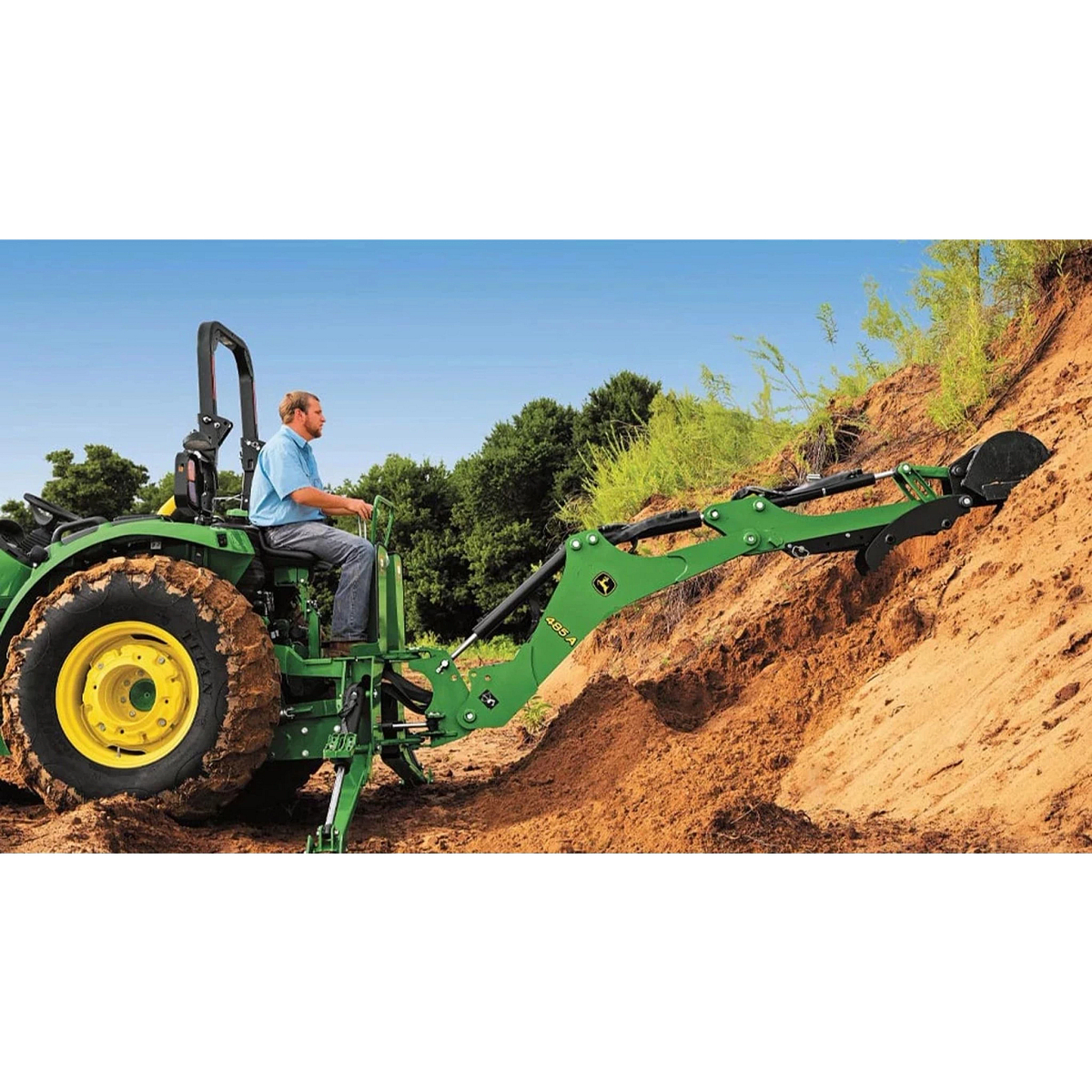 farmer on a 4044R Compact Tractor enforcing a dirt hill