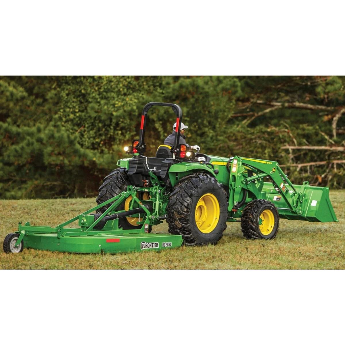 4066M Heavy Duty Compact Tractors with a close up of a tractor with a trailer on a field