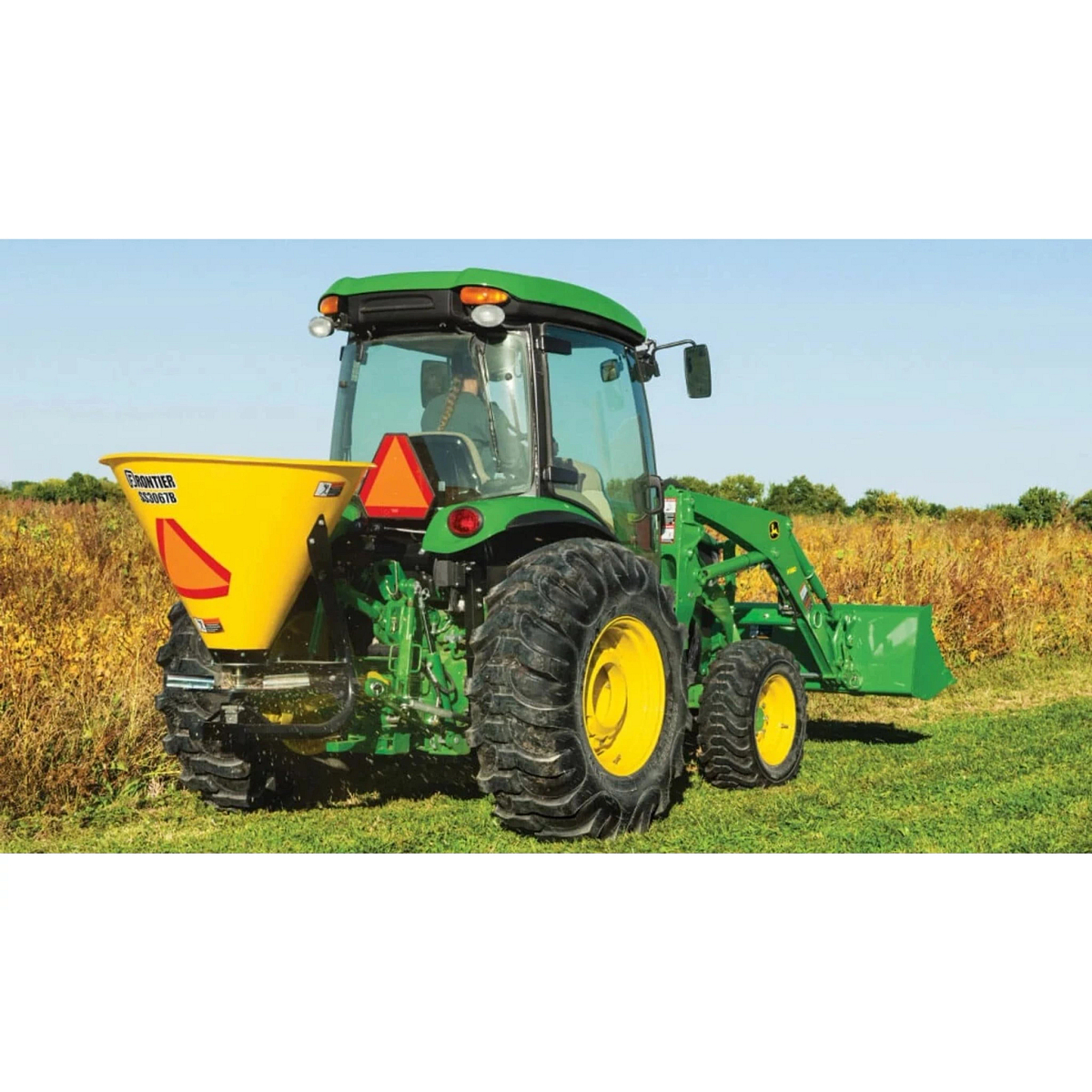 4066R Compact Tractor with a close up of a tractor with a spreader on a field