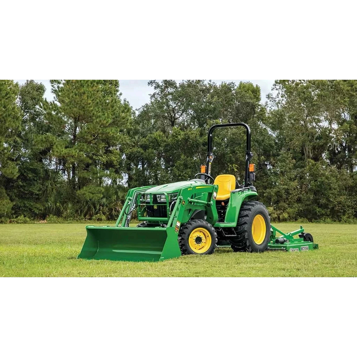 3025E 3 Series Compact Tractors with a green tractor with a plow attachment in a field