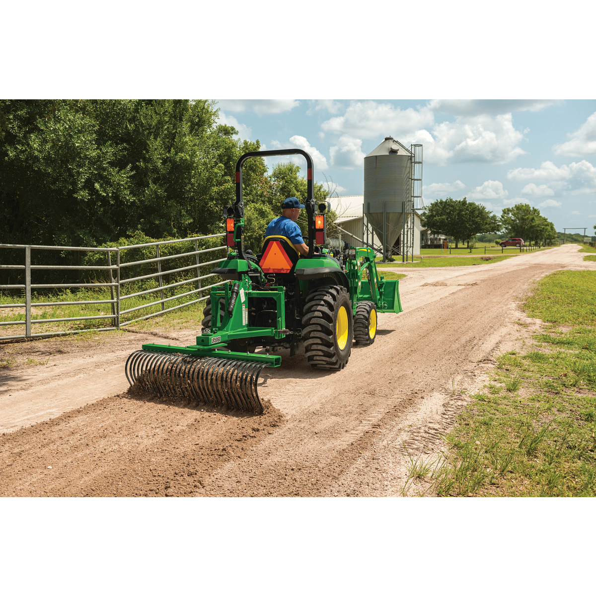 Raking dirt driveway with a 2032R Tractor using a LR5060 Landscape Rake