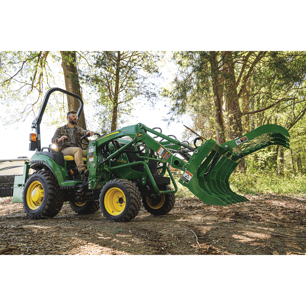Tractor with Root Grapple in forest