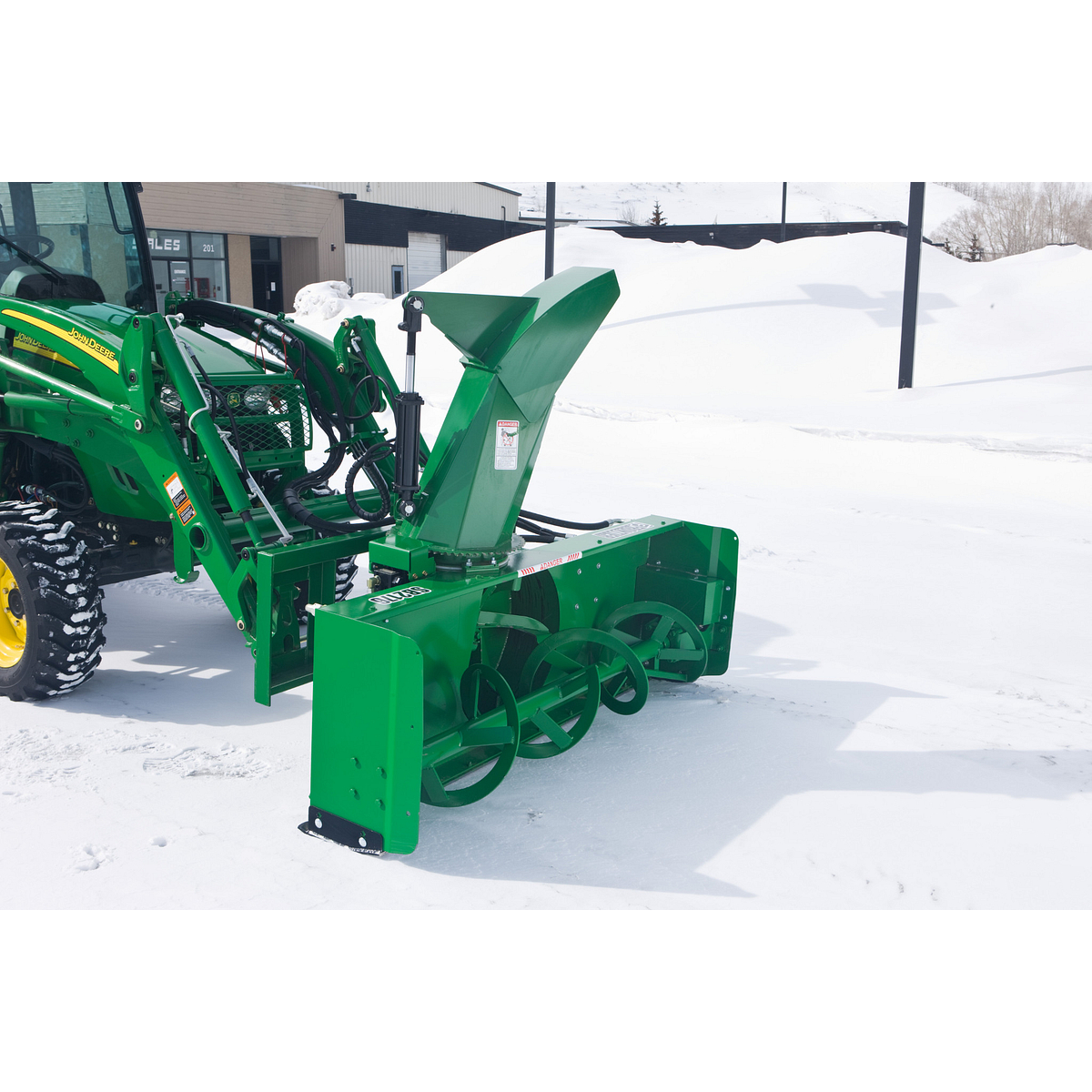 SB2176 Snowblower attached to a utility tractor sitting on a snowy drive