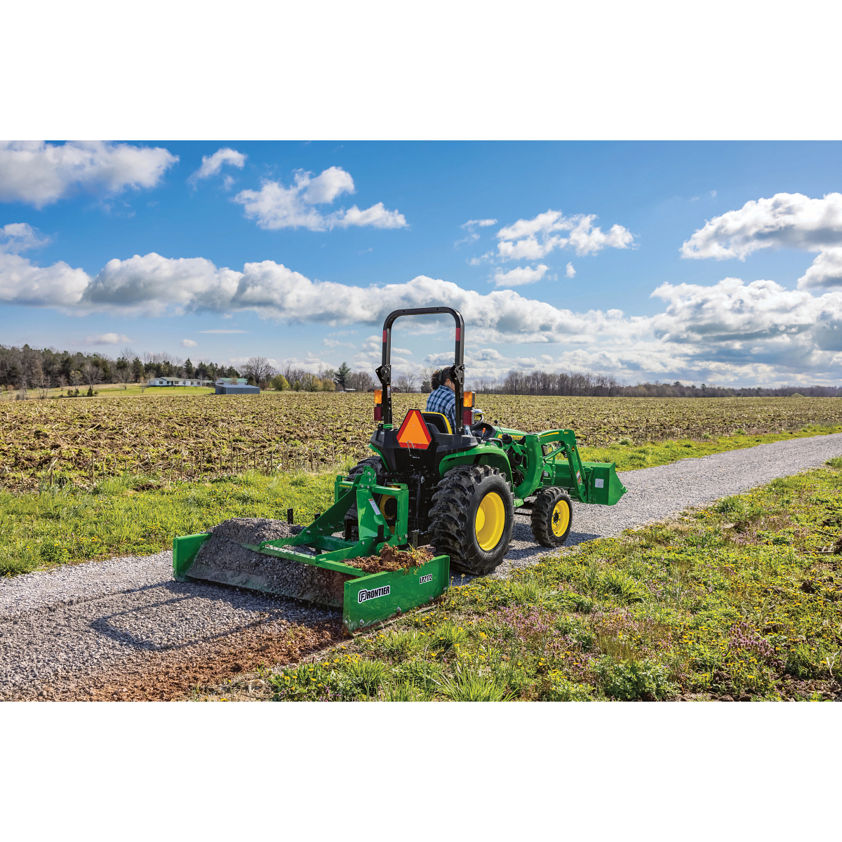 LP2172 Land Plane on 3038E Tractor leveling gravel on path in a field