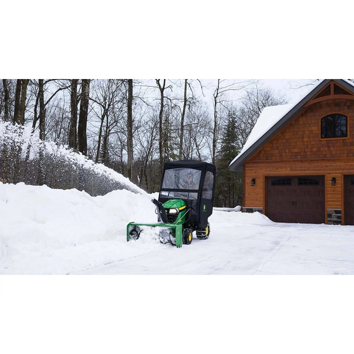 X350 Select Series Lawn Tractor with a snow blower attachment plowing a driveway