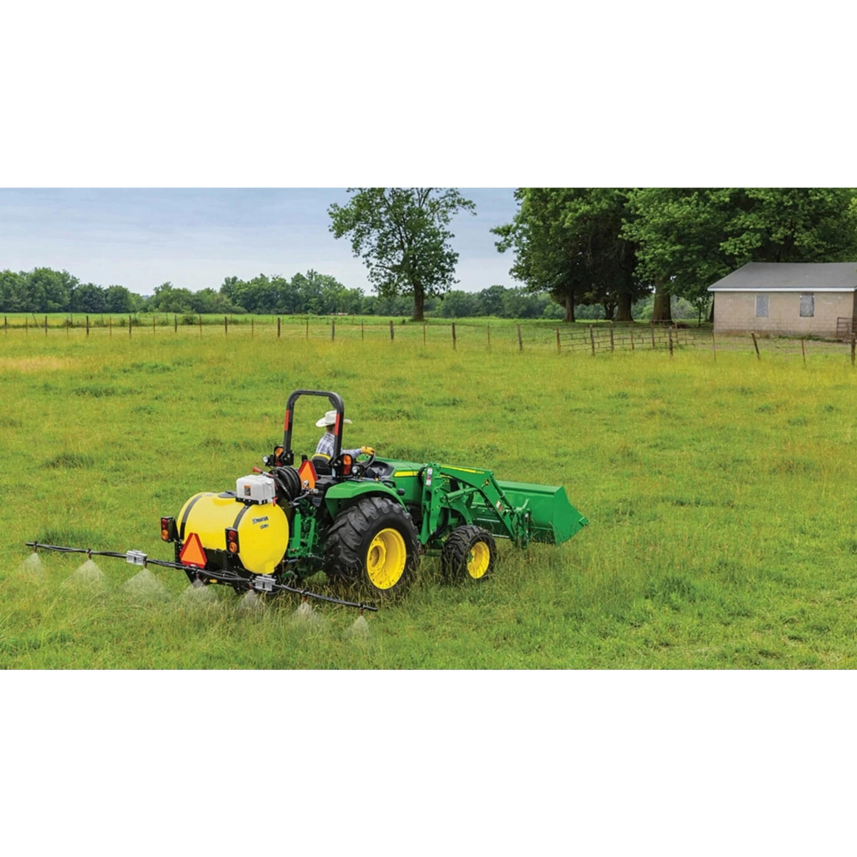 4066M Heavy Duty Compact Tractors with a farmer is spraying a field with a sprayer
