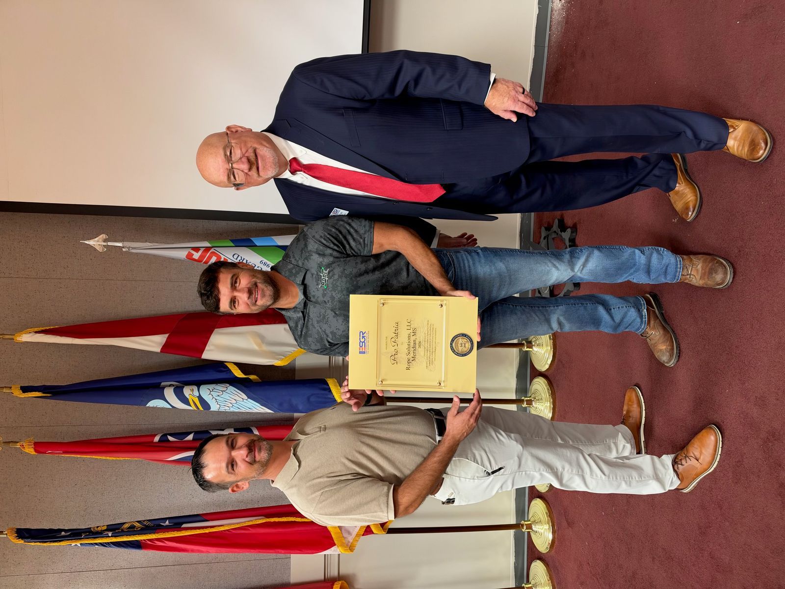 ROPE teammates holding the Pro Patria Award certificate