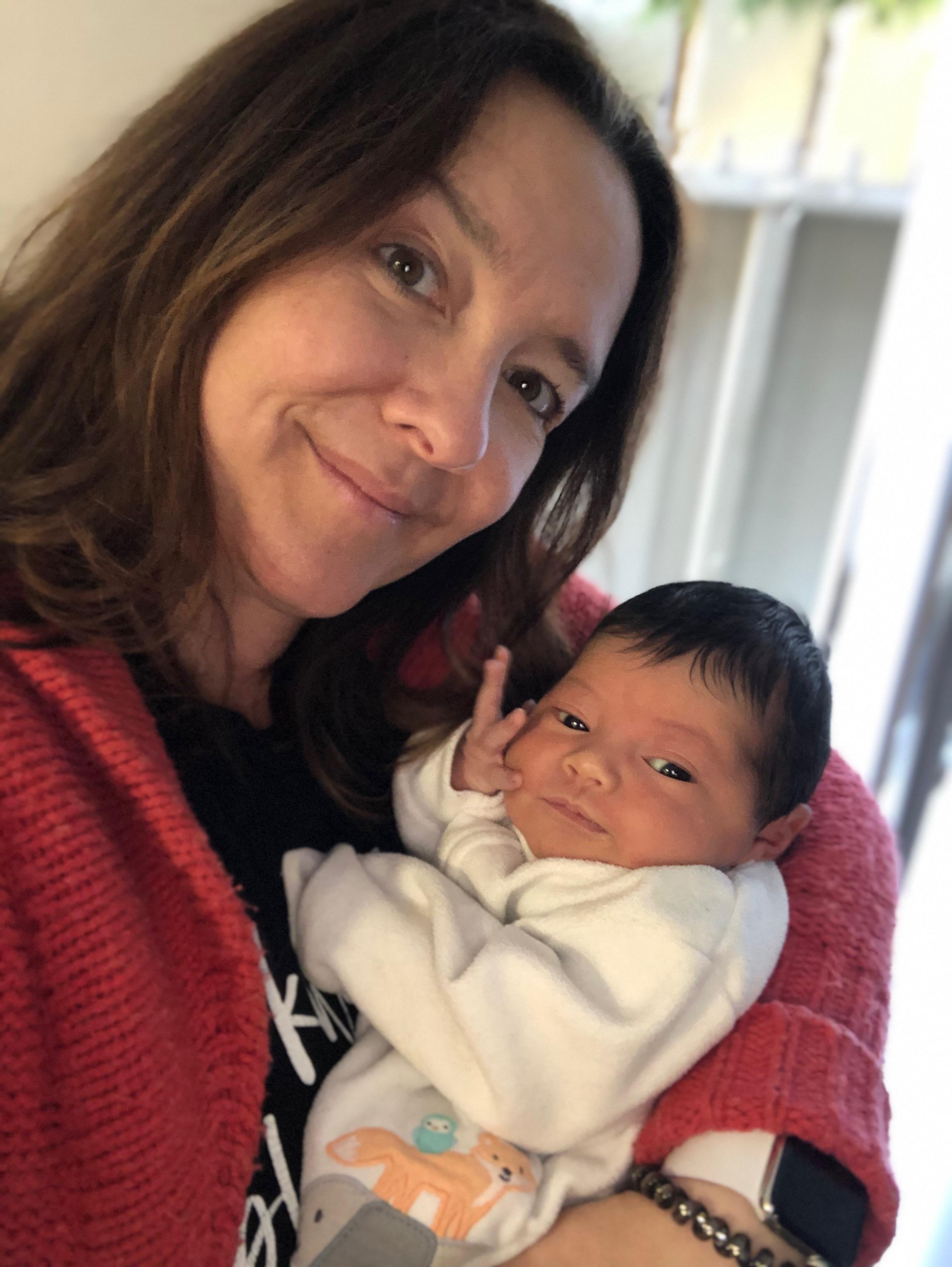 Kirsten Dudley holding a newborn baby