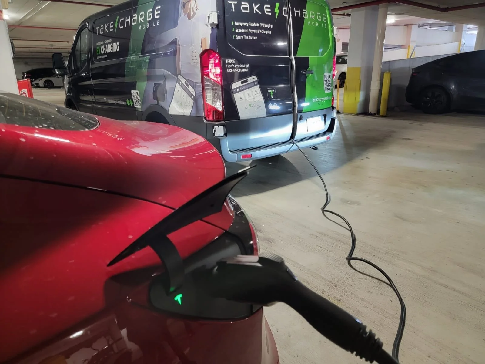 Take Charge Mobile van charging an EV in a parking garage