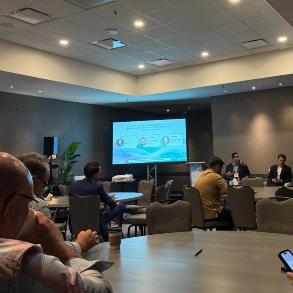 Panel discussion at Metro Connect Fall in Austin, with speakers seated beside a presentation screen and attendees at tables