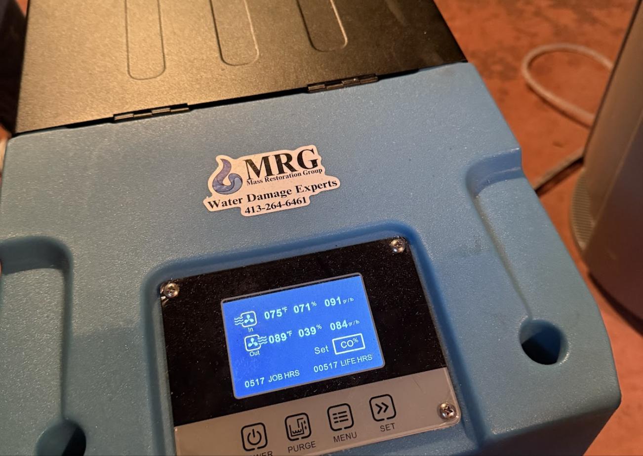 Mass Restoration Group commercial dehumidifier drying a Hampden County, MA property with live moisture readings