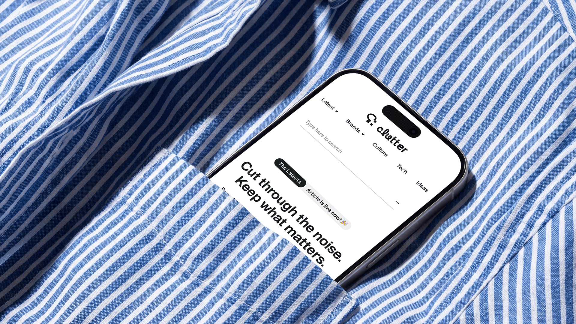 iPhone displaying a clutter's homepage tucked into the pocket of a blue and white striped shirt.